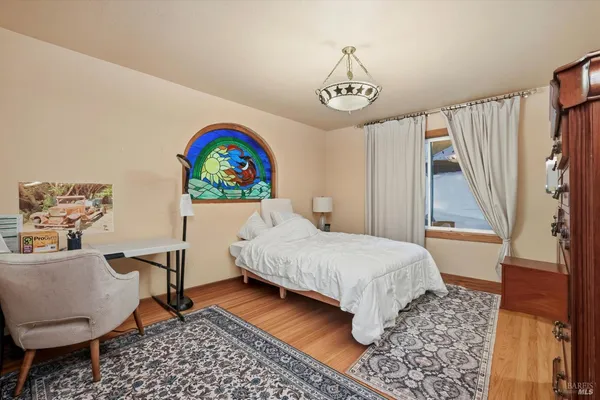 a bedroom with a bed and a chandelier