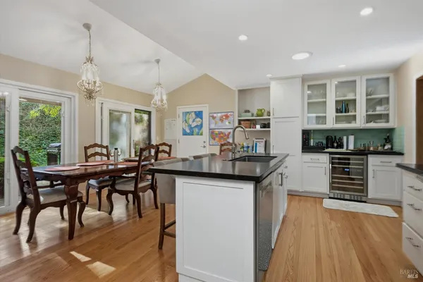 a kitchen with stainless steel appliances granite countertop a stove and a wooden floors