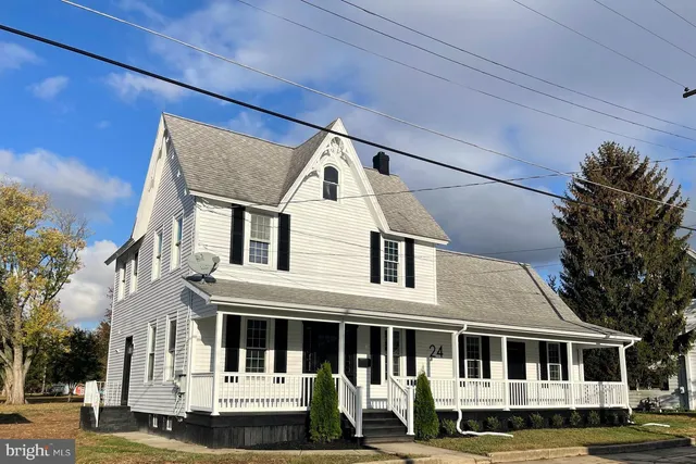 a front view of a large white house