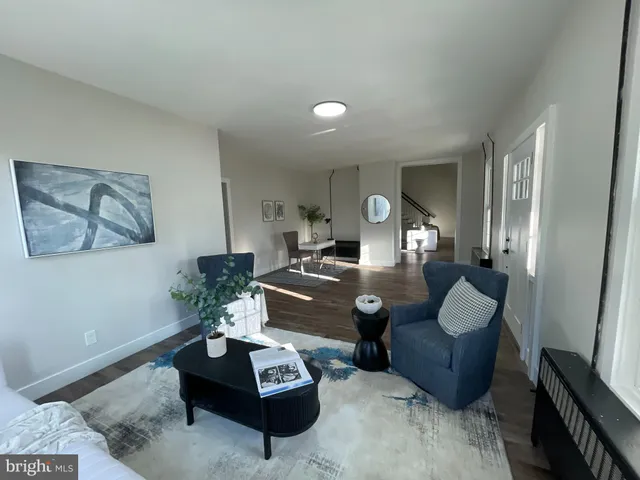 a large white kitchen with a sink and dishwasher a stove with wooden floor