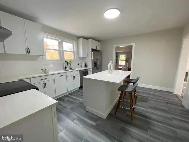 a kitchen with a sink appliances and cabinets
