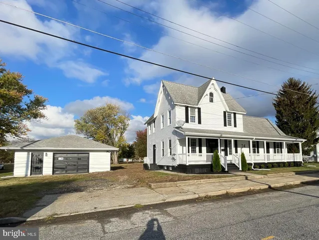 a view of a big house with a street