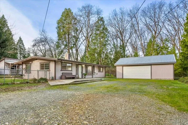 a white house that has a tree in front of it