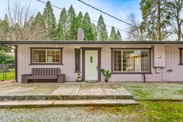 a front view of a house with a yard table and chairs