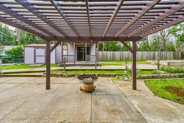 a view of a backyard with plants and patio