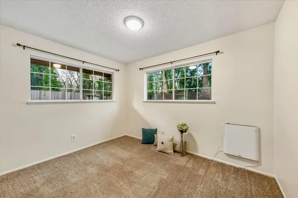a view of a room with furniture and windows
