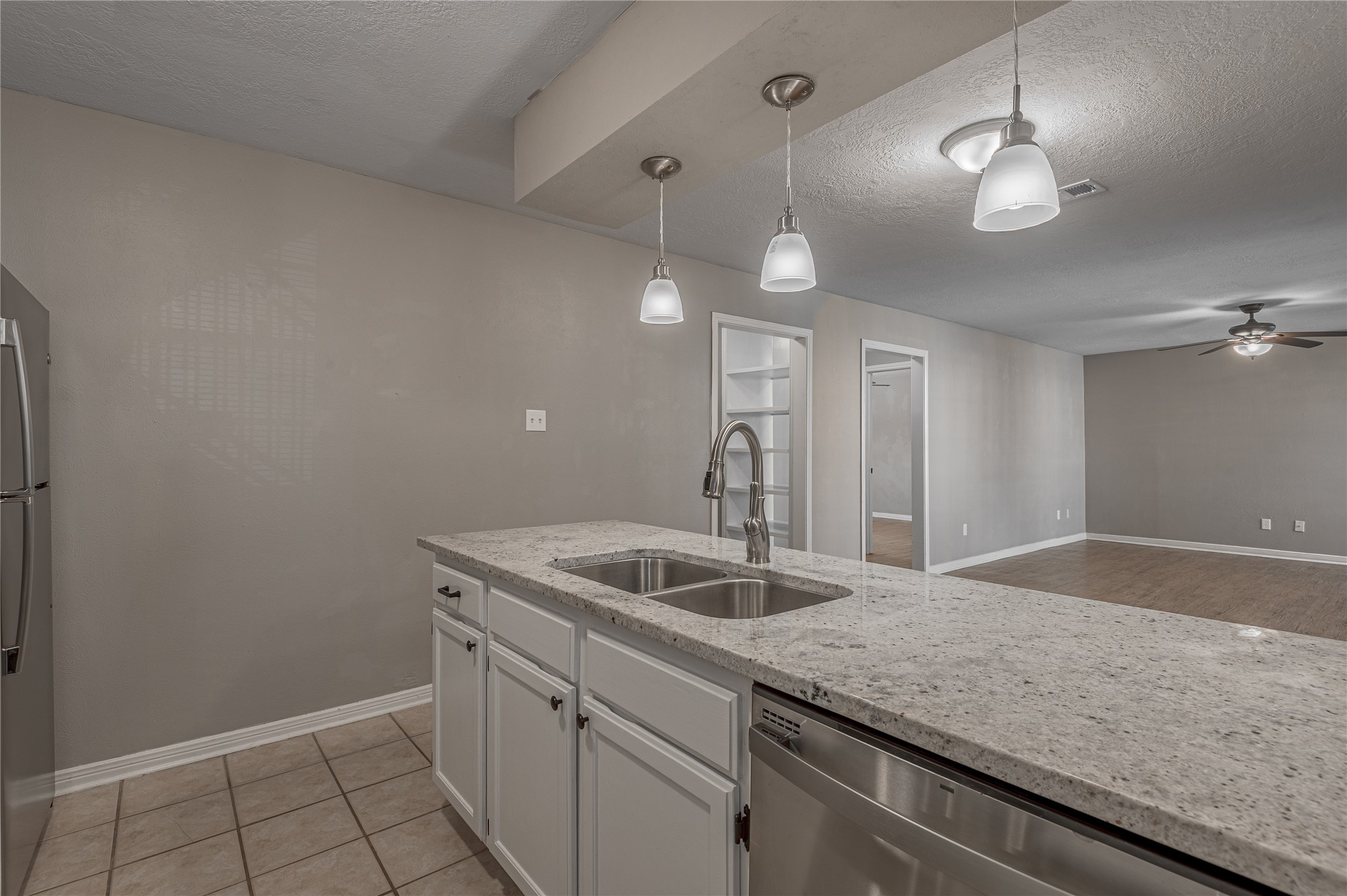 2402 Sycamore Avenue, Unit E2 Huntsville, TX 77340 - Photo 14 of 43 a kitchen with a sink and chandelier