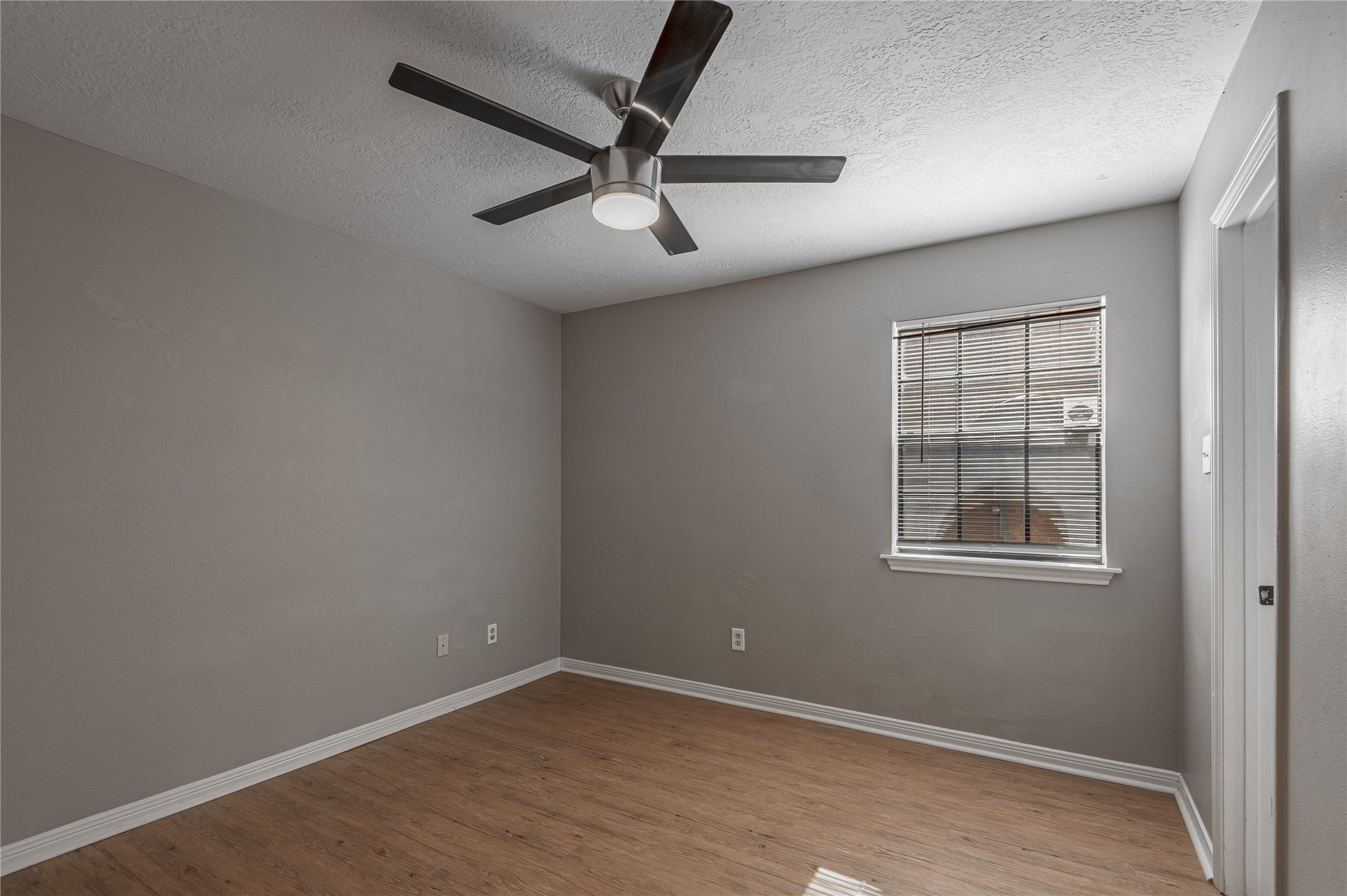 2402 Sycamore Avenue, Unit E2 Huntsville, TX 77340 - Photo 17 of 43 an empty room with windows and fan