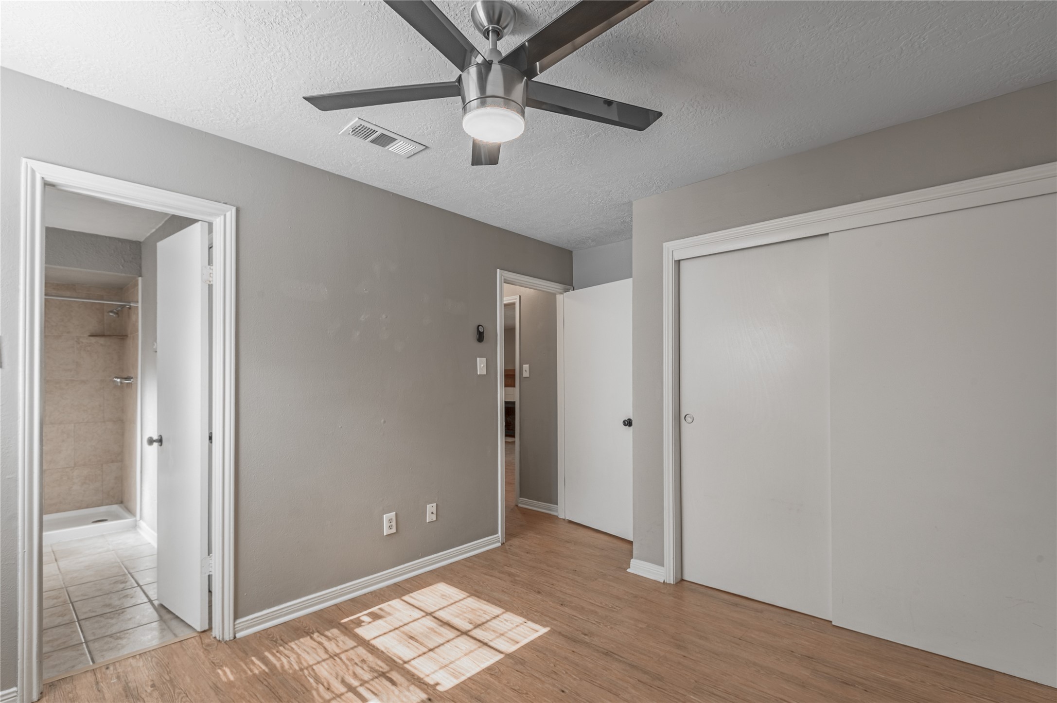 2402 Sycamore Avenue, Unit E2 Huntsville, TX 77340 - Photo 19 of 43 a view of an empty room with wooden floor