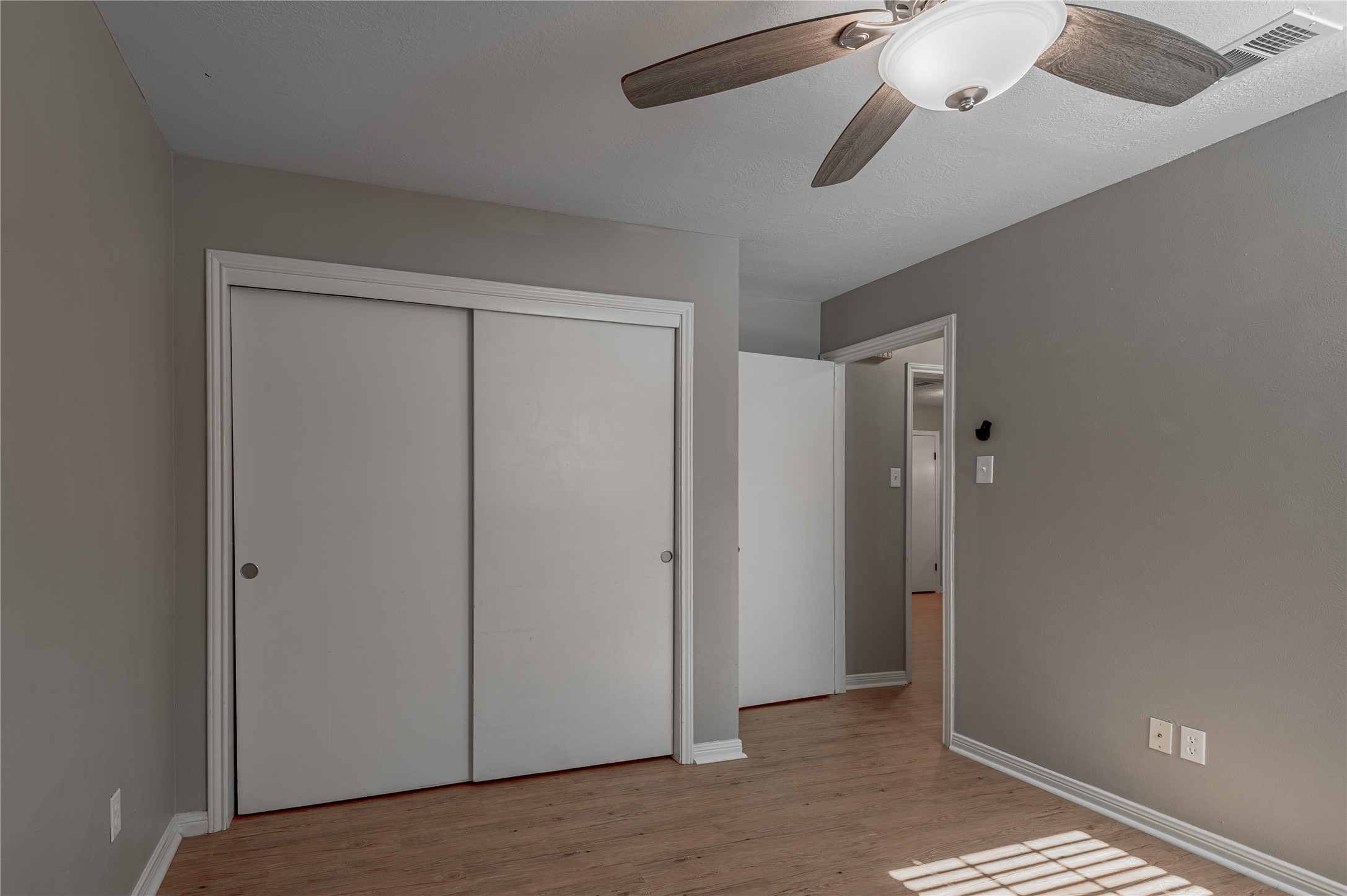 2402 Sycamore Avenue, Unit E2 Huntsville, TX 77340 - Photo 24 of 43 an empty room with windows and fan