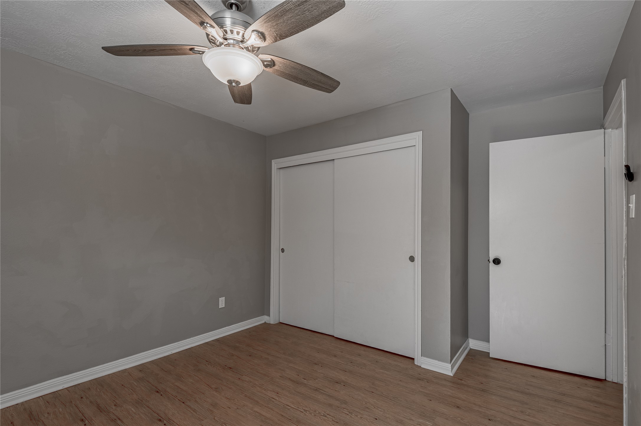 2402 Sycamore Avenue, Unit E2 Huntsville, TX 77340 - Photo 25 of 43 a view of an empty room with wooden floor