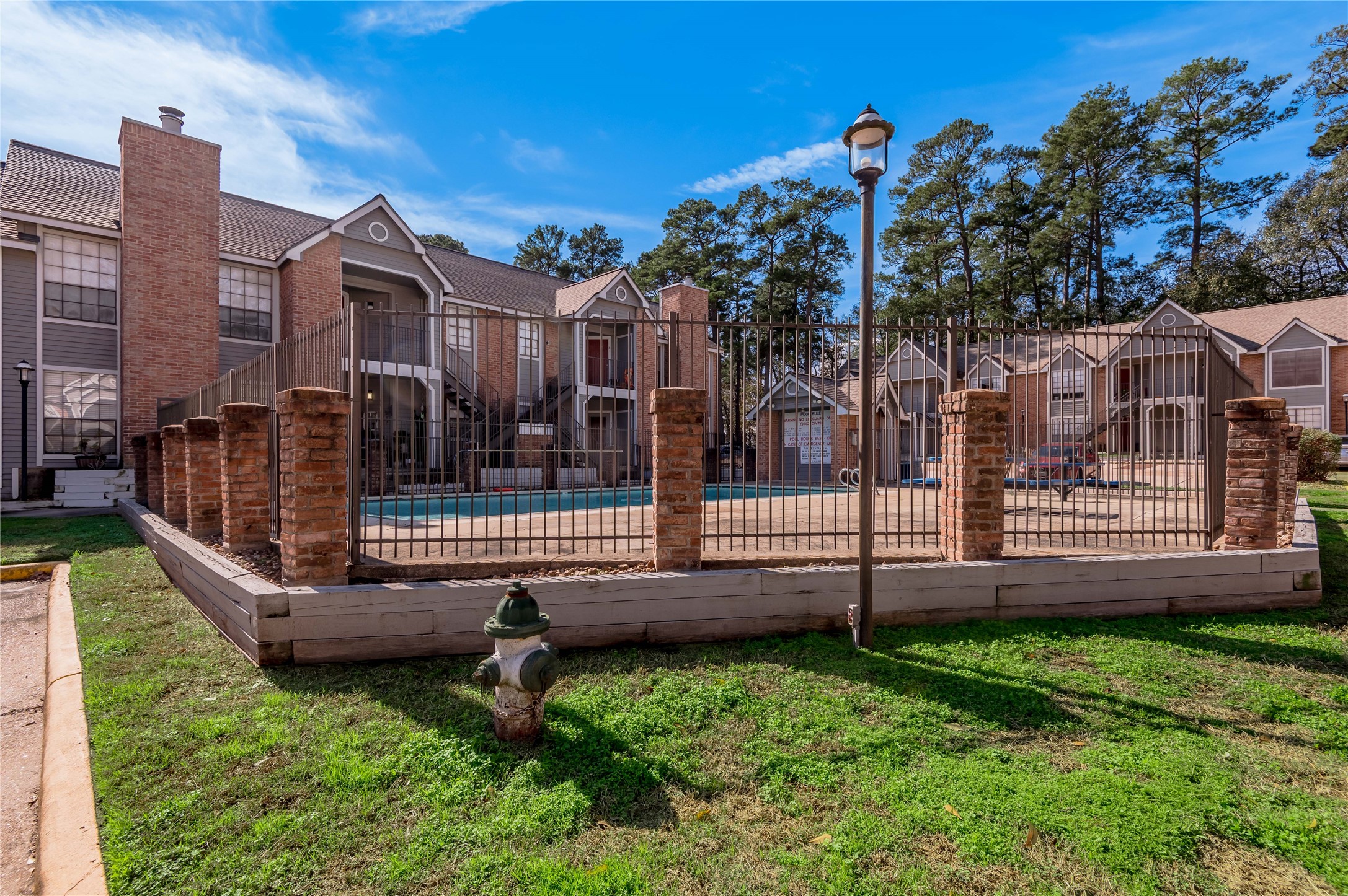 2402 Sycamore Avenue, Unit E2 Huntsville, TX 77340 - Photo 28 of 43 a view of a house with backyard and wooden fence