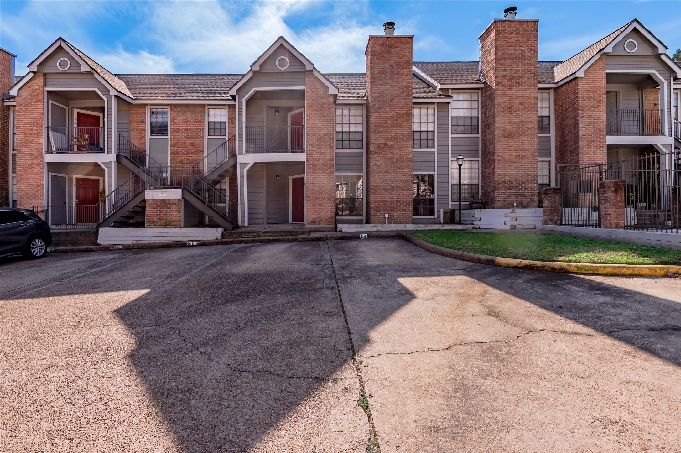 2402 Sycamore Avenue, Unit E2 Huntsville, TX 77340 - Photo 29 of 43 a front view of a house with a yard