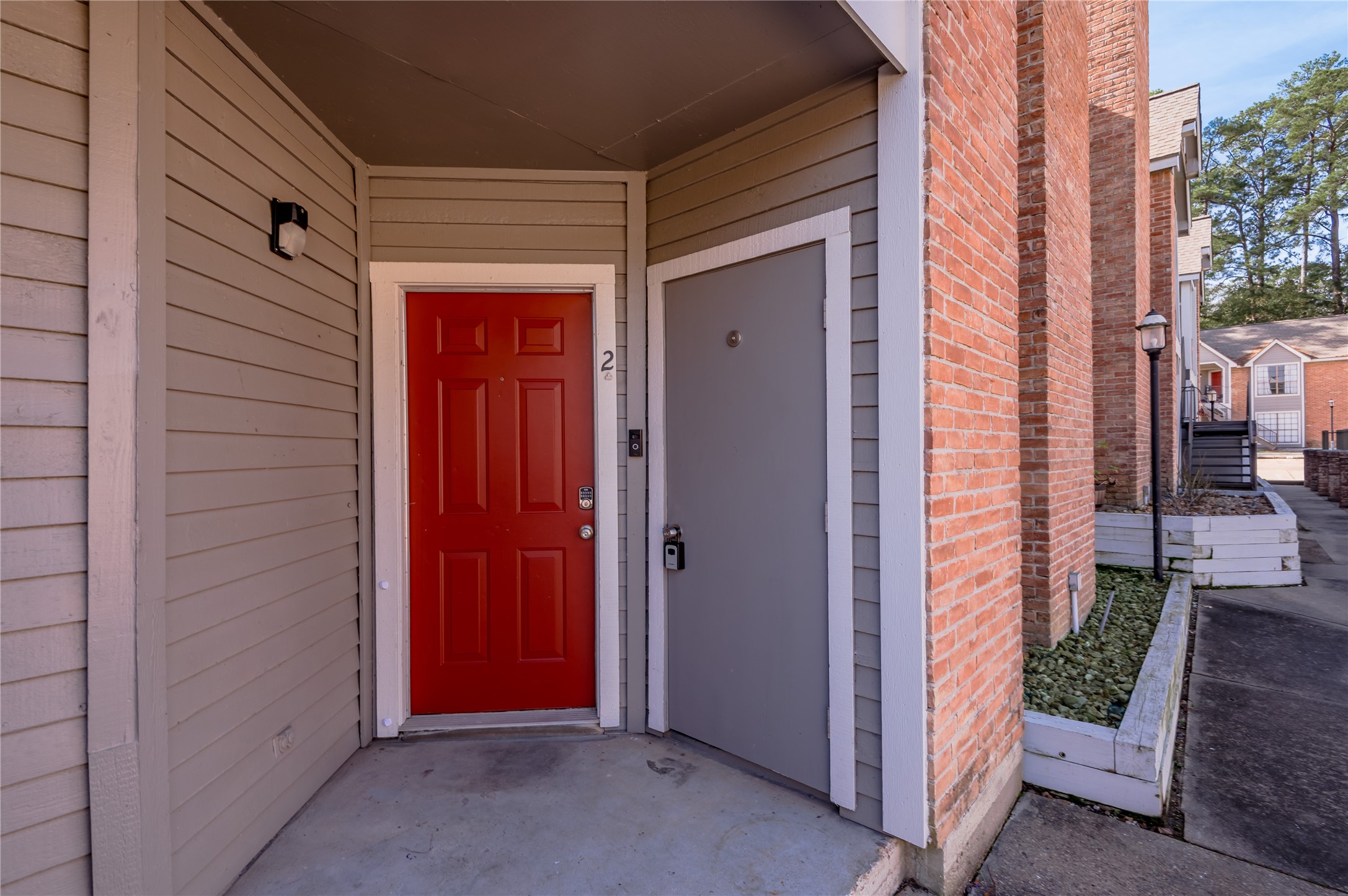 2402 Sycamore Avenue, Unit E2 Huntsville, TX 77340 - Photo 3 of 43 an entrance view of a house with a door and chair