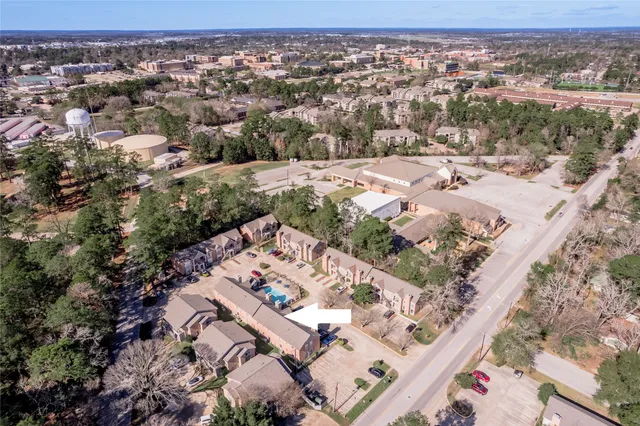 an aerial view of residential houses with outdoor space