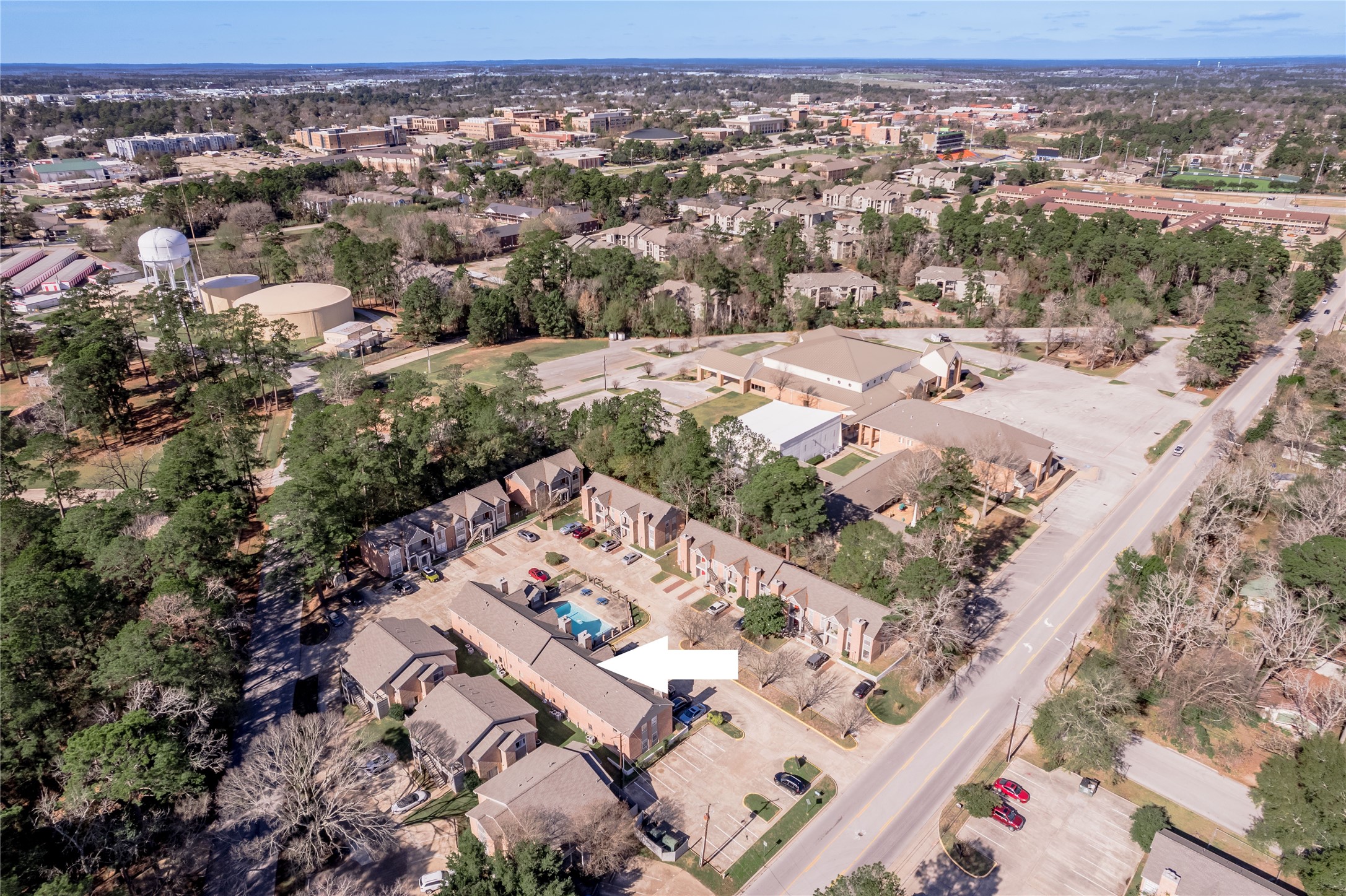 2402 Sycamore Avenue, Unit E2 Huntsville, TX 77340 - Photo 5 of 43 an aerial view of residential houses with outdoor space