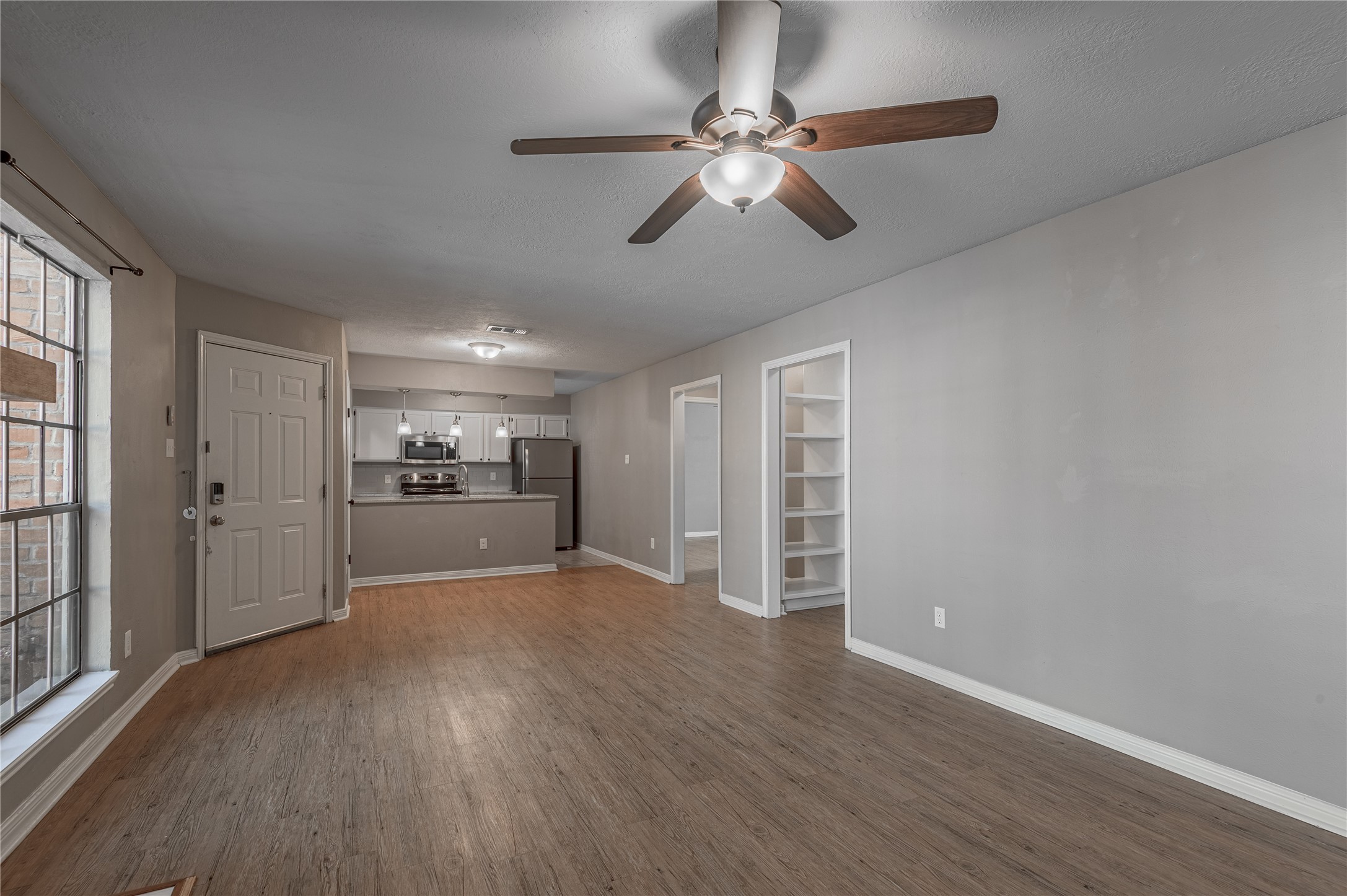 2402 Sycamore Avenue, Unit E2 Huntsville, TX 77340 - Photo 9 of 43 a view of a kitchen with wooden floor and a window