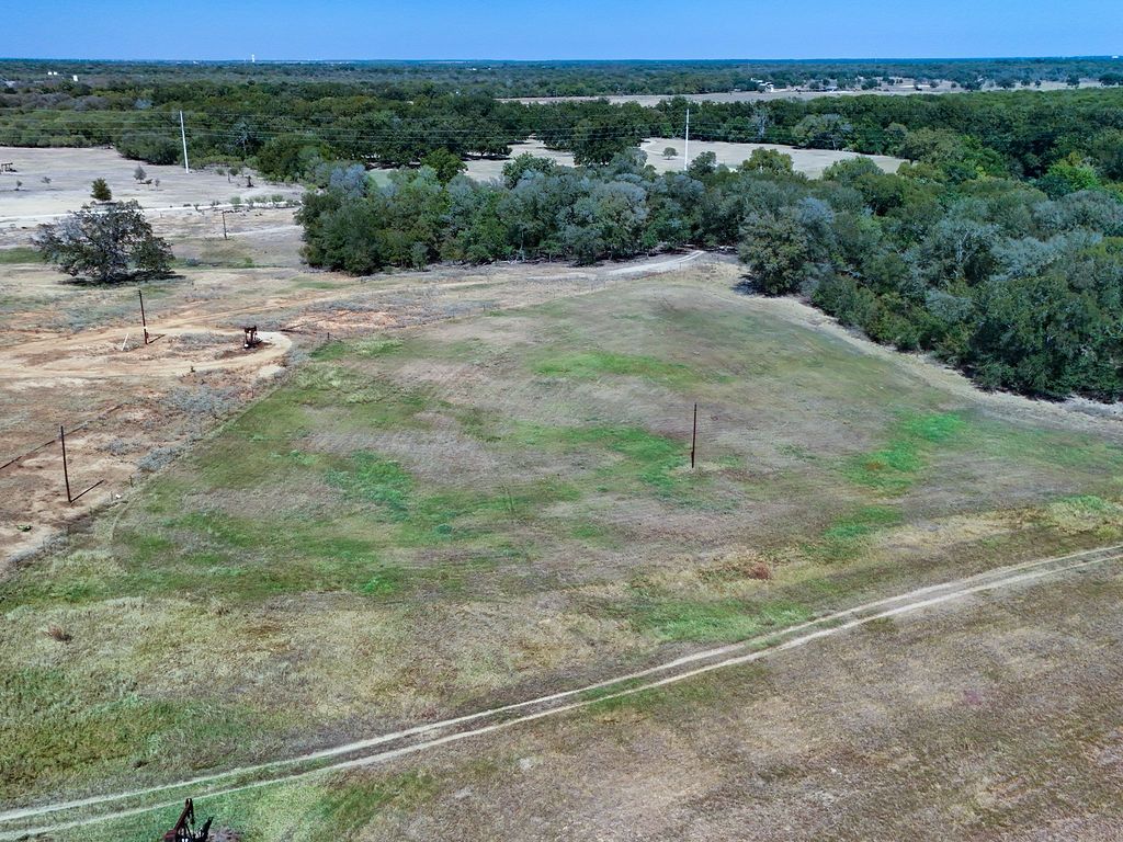 5400 Gander Slough Road Kingsbury, TX 78638 - Photo 18 of 40 a view of a field of grass and a building