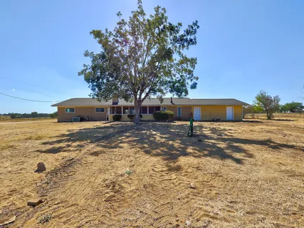 a view of an empty room with a fireplace