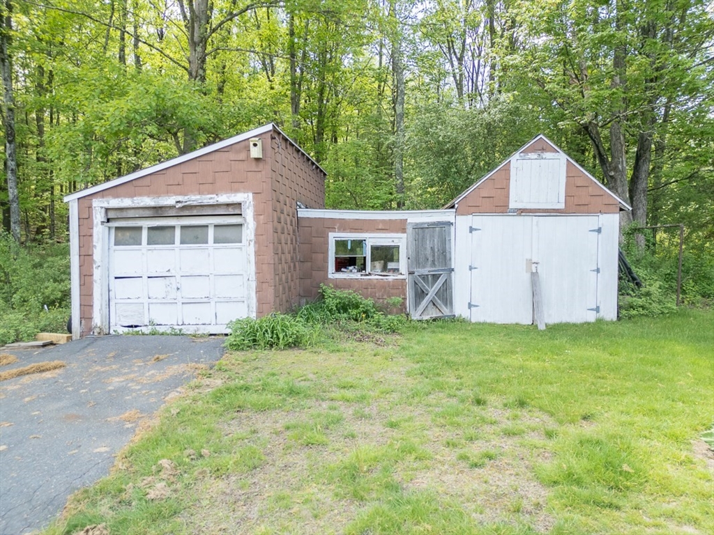 92 Squannacook Road Shirley, MA 01464 - Photo 28 of 38 a front view of a house with a yard and garage