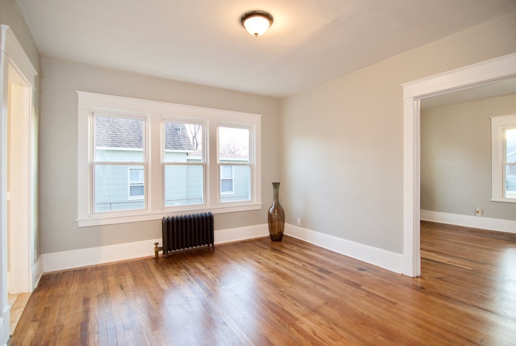 81 Haskin Street Springfield, MA 01109 - Photo 11 of 39 an empty room with wooden floor and windows