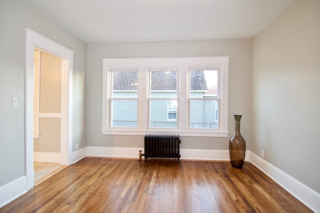 81 Haskin Street Springfield, MA 01109 - Photo 14 of 39 an empty room with wooden floor and windows