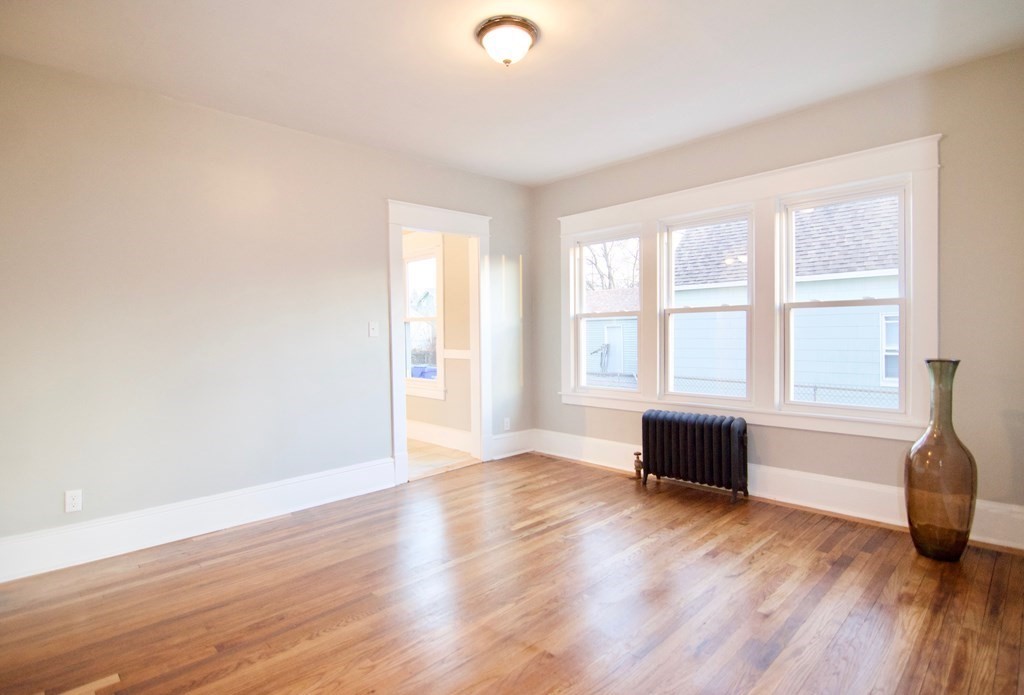 81 Haskin Street Springfield, MA 01109 - Photo 15 of 39 an empty room with wooden floor and windows