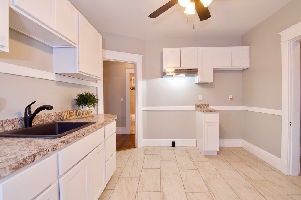 81 Haskin Street Springfield, MA 01109 - Photo 20 of 39 a kitchen with stainless steel appliances granite countertop a sink and a refrigerator