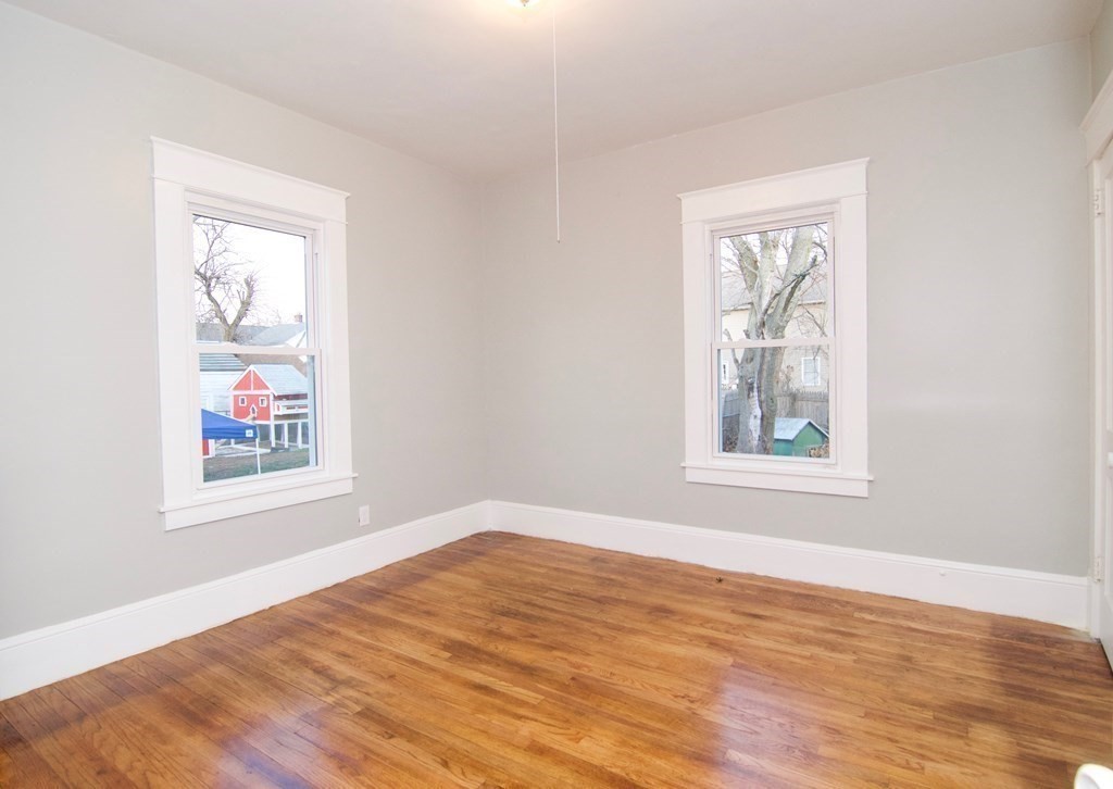 81 Haskin Street Springfield, MA 01109 - Photo 26 of 39 an empty room with wooden floor and windows