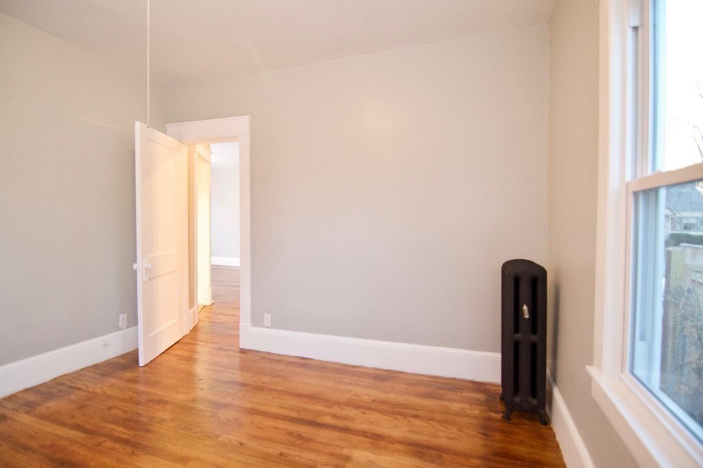 81 Haskin Street Springfield, MA 01109 - Photo 28 of 39 a view of an empty room with wooden floor and a window
