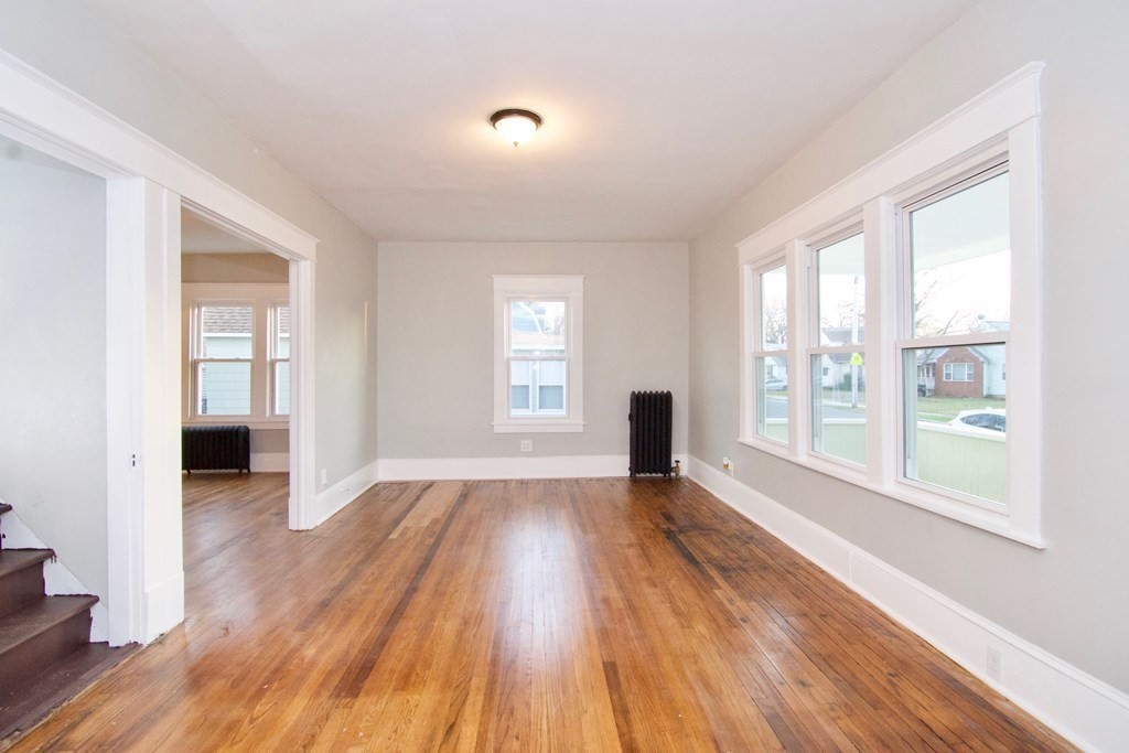 81 Haskin Street Springfield, MA 01109 - Photo 3 of 39 an empty room with wooden floor and windows