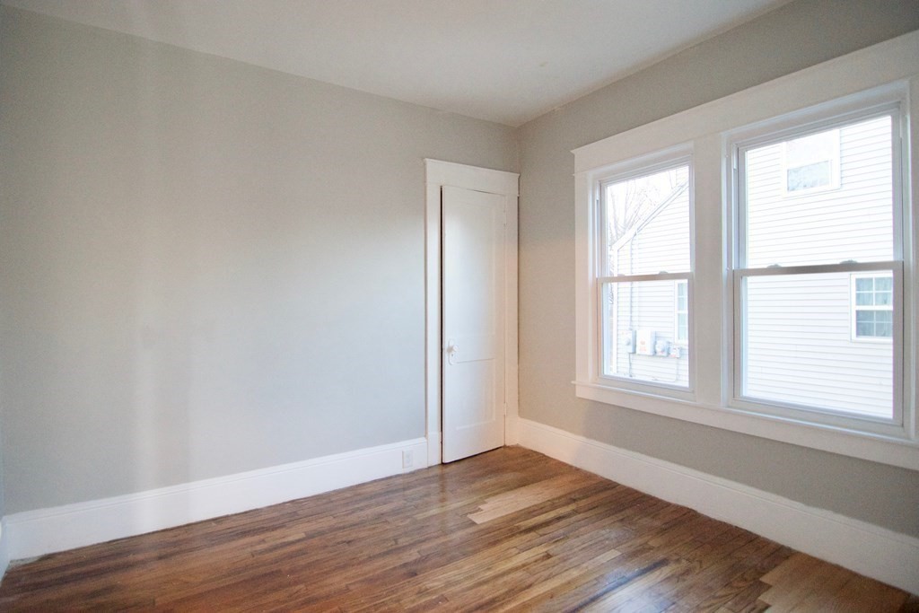 81 Haskin Street Springfield, MA 01109 - Photo 31 of 39 an empty room with wooden floor and windows