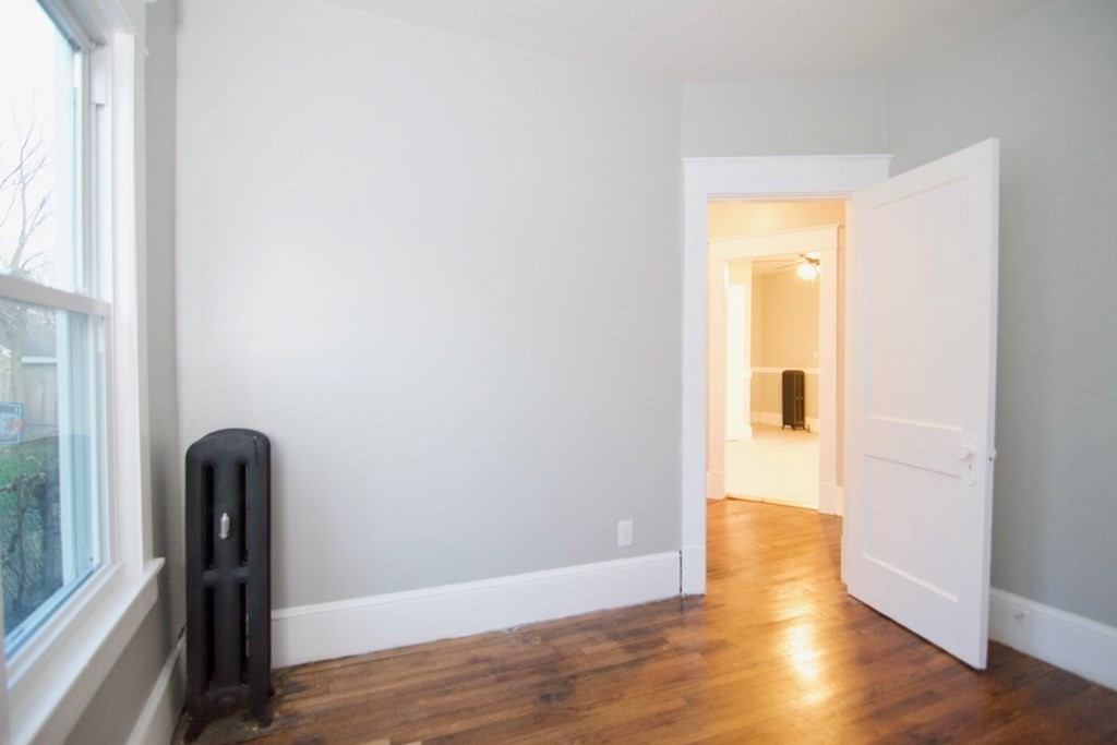 81 Haskin Street Springfield, MA 01109 - Photo 34 of 39 an empty room with wooden floor and a window