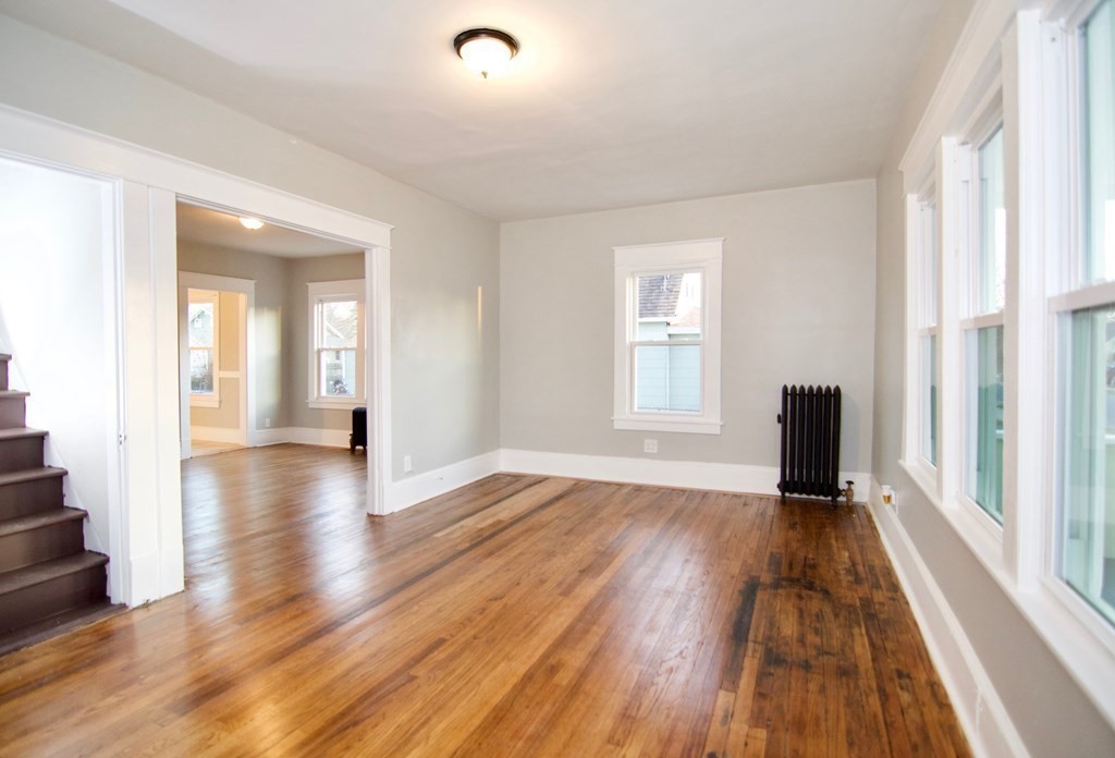 81 Haskin Street Springfield, MA 01109 - Photo 4 of 39 wooden floor in an empty room with a window