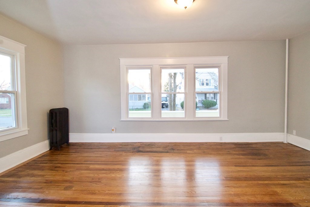 81 Haskin Street Springfield, MA 01109 - Photo 5 of 39 a view of an empty room with wooden floor and a window