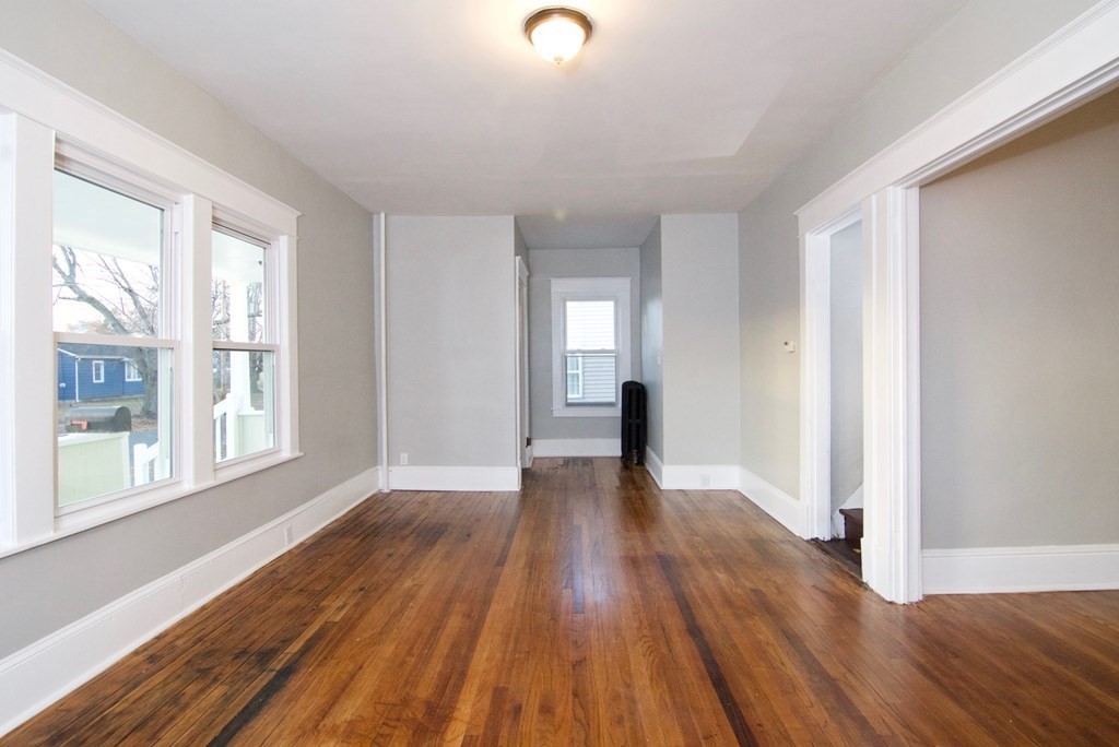 81 Haskin Street Springfield, MA 01109 - Photo 6 of 39 a view of an empty room with wooden floor and a window