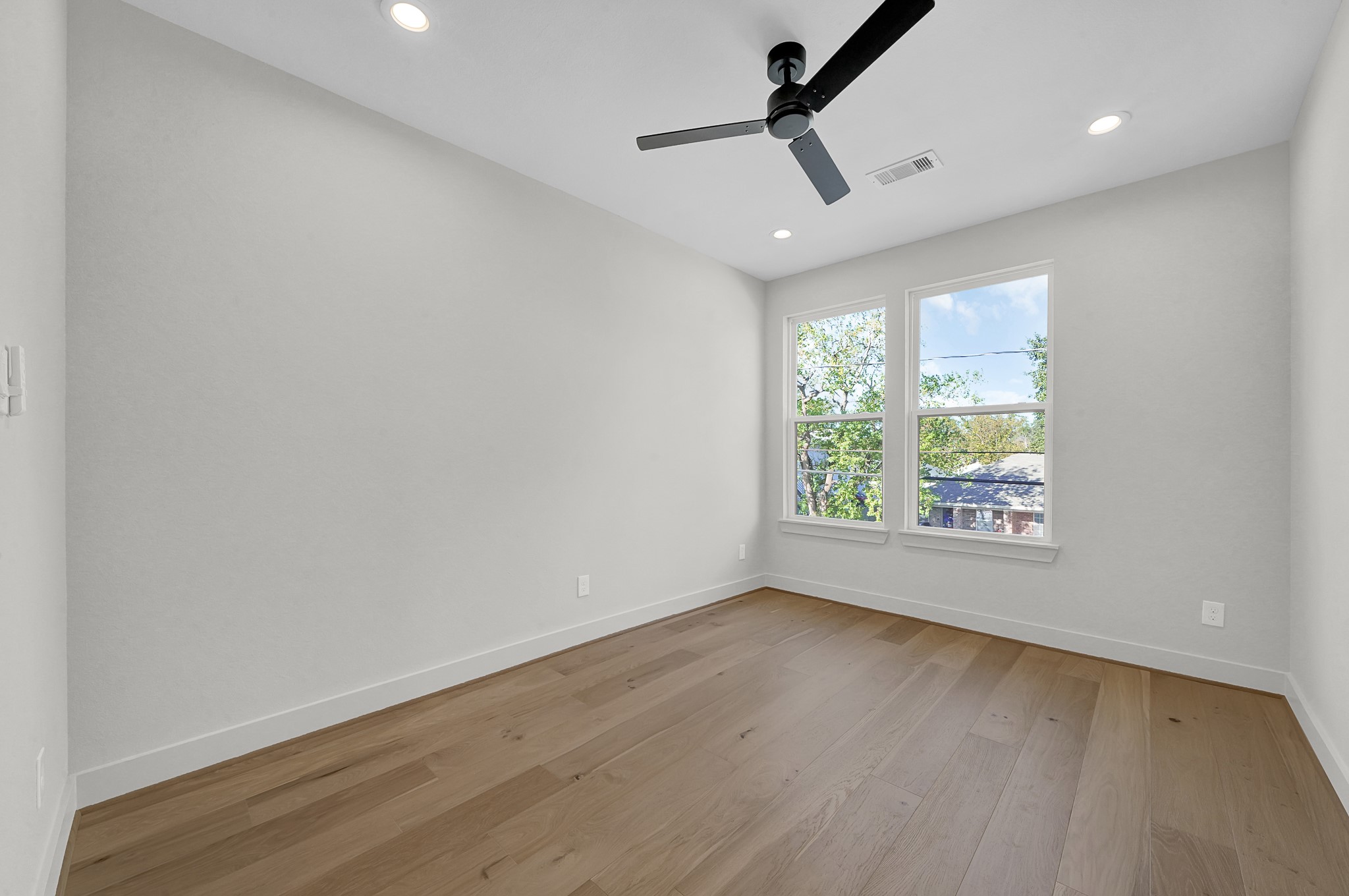 3630 Lydia Street Houston, TX 77021 - Photo 21 of 27 an empty room with wooden floor and windows