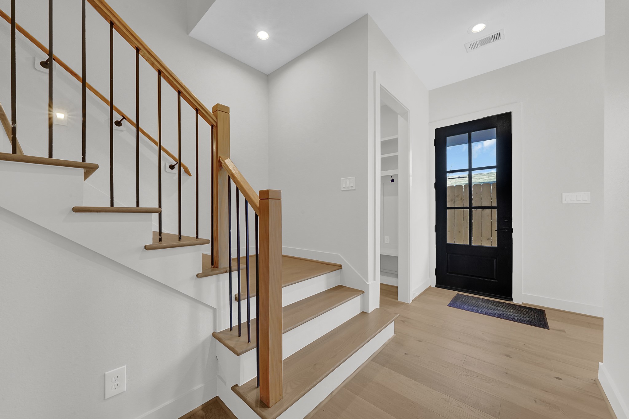 3630 Lydia Street Houston, TX 77021 - Photo 4 of 27 a view of staircase with white walls and lots of frames on wall