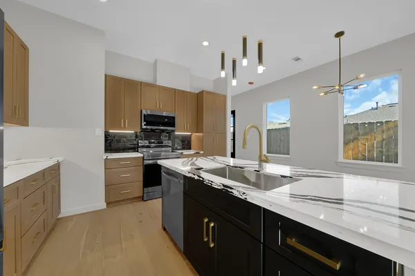 a large white kitchen with a large window