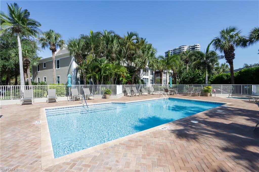 5895 Chanteclair Drive, Unit 114 Naples, FL 34108 - Photo 19 of 21 Community pool featuring a patio