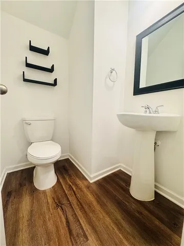 a bathroom with a toilet and a mirror