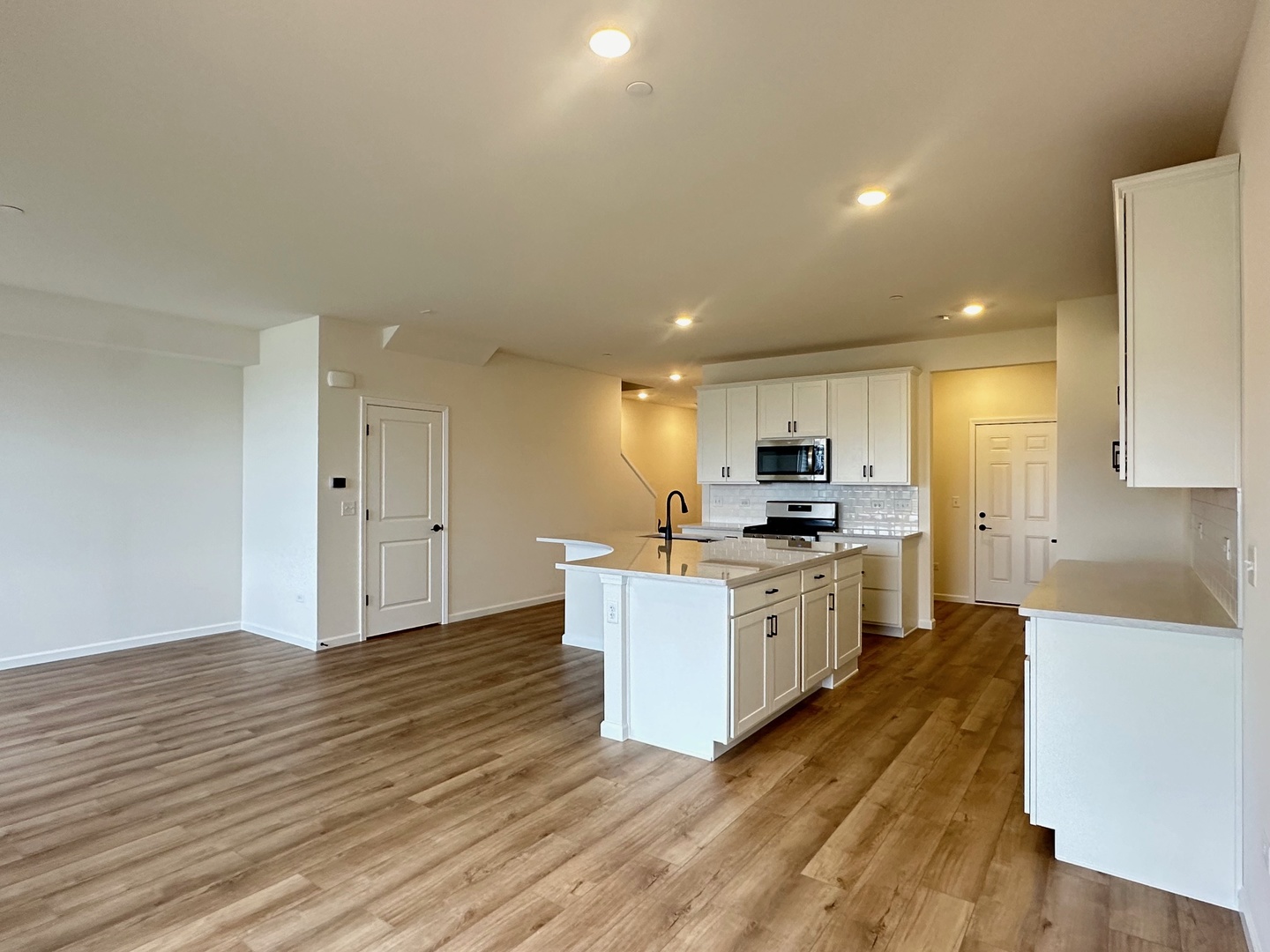 5949 Hawkweed Drive Plainfield, IL 60585 - Photo 11 of 25 a large kitchen with kitchen island a sink dishwasher stove top oven and cabinets