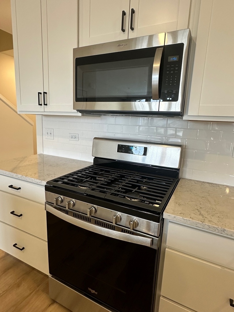 5949 Hawkweed Drive Plainfield, IL 60585 - Photo 12 of 25 a stove top oven sitting inside of a kitchen