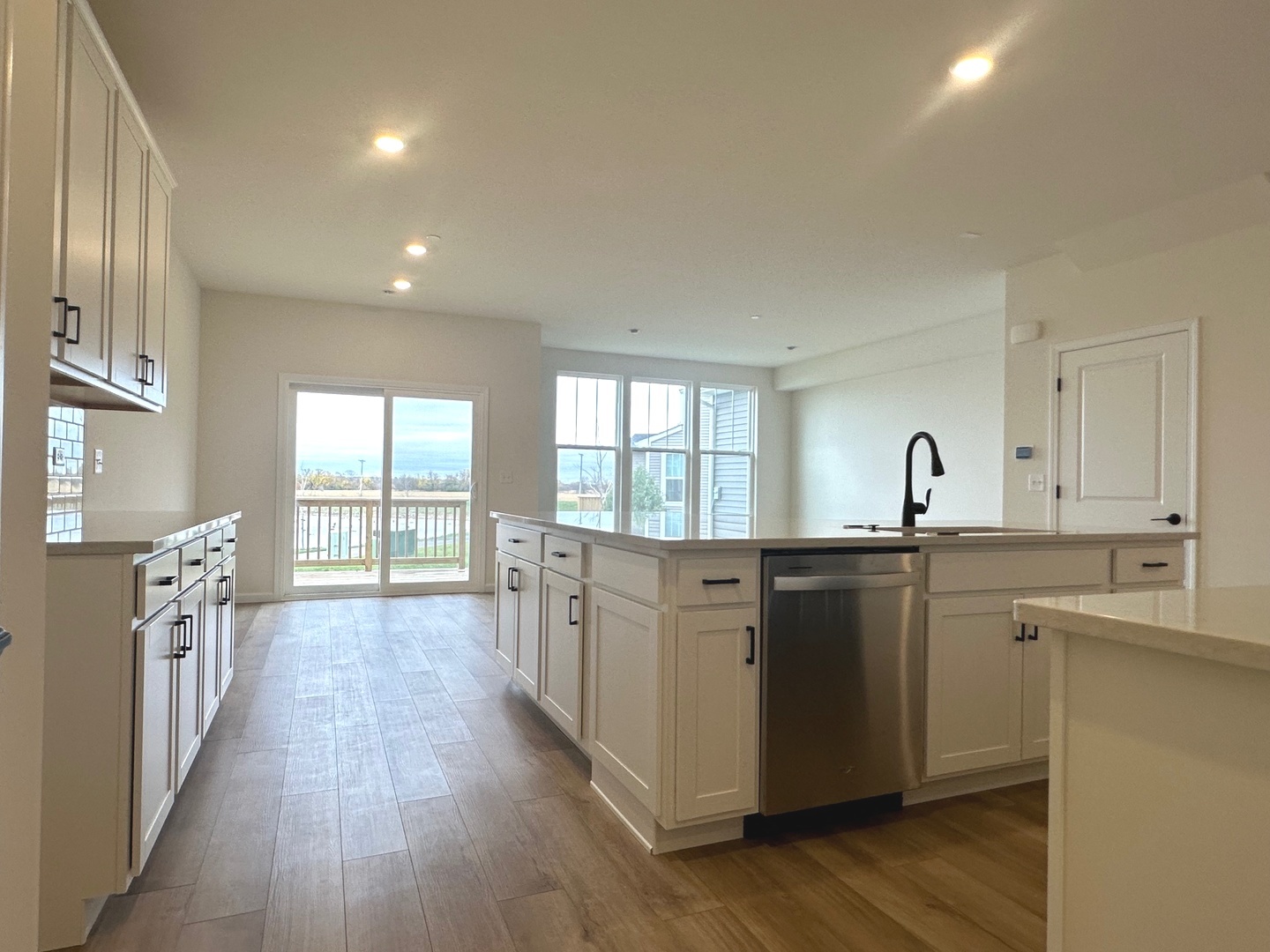 5949 Hawkweed Drive Plainfield, IL 60585 - Photo 5 of 25 a open kitchen with cabinets a sink and wooden floor