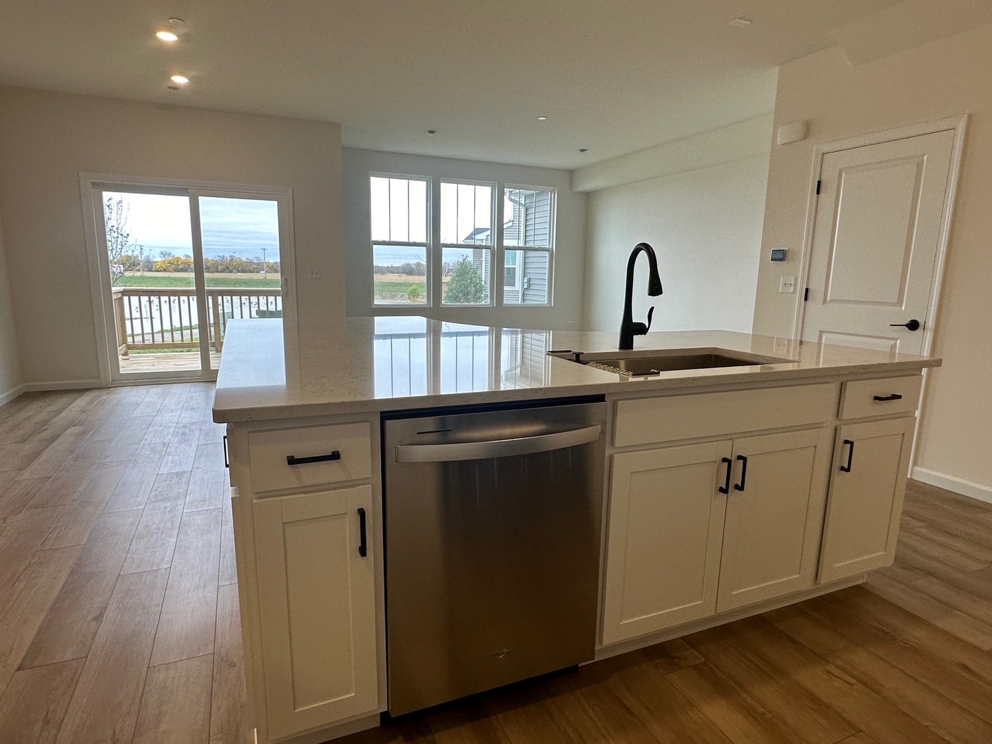 5949 Hawkweed Drive Plainfield, IL 60585 - Photo 7 of 25 a kitchen with stainless steel appliances granite countertop a sink a stove cabinets and wooden floor