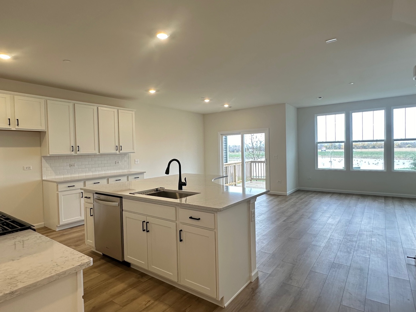 5949 Hawkweed Drive Plainfield, IL 60585 - Photo 8 of 25 a kitchen with a sink stove and cabinets