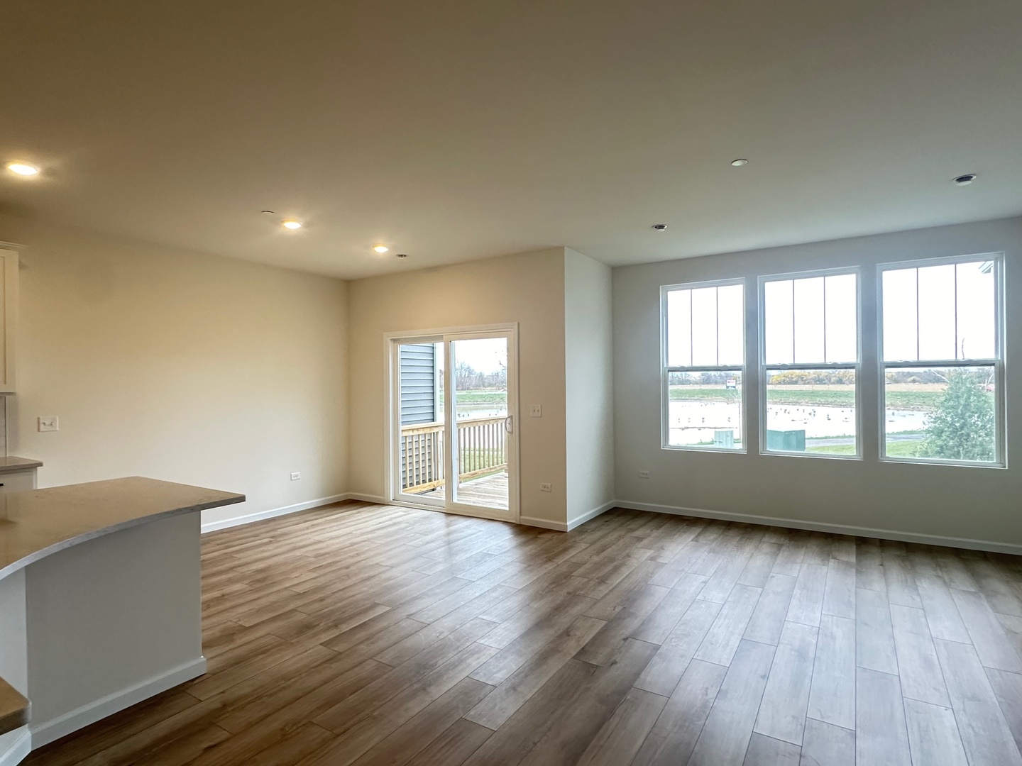 5949 Hawkweed Drive Plainfield, IL 60585 - Photo 9 of 25 a view of an empty room with wooden floor and a window