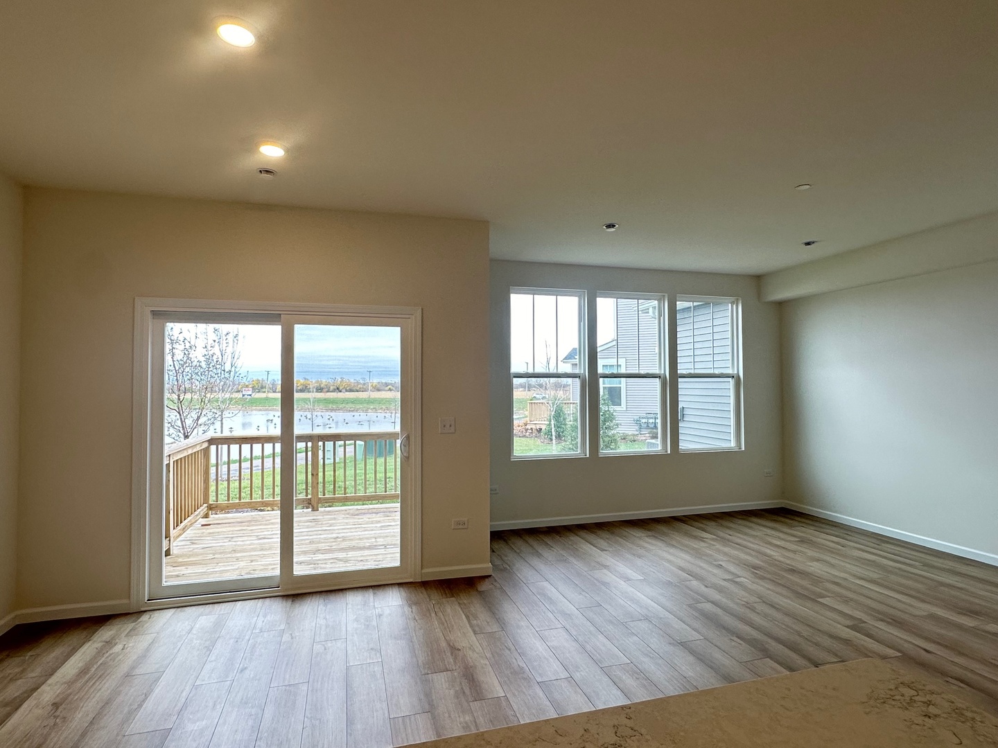 5949 Hawkweed Drive Plainfield, IL 60585 - Photo 10 of 25 a view of an empty room with wooden floor and a window