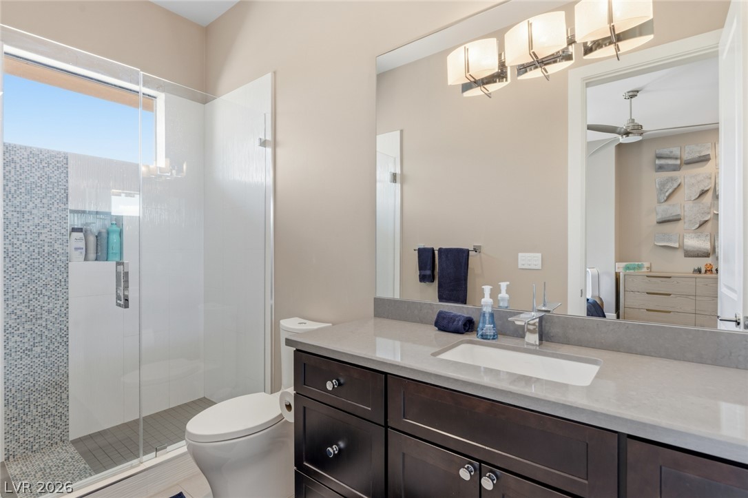 5 Crystal Tree Pass Henderson, NV 89052 - Photo 30 of 67 A refined bathroom features a spacious vanity with an undermount sink and a glass-enclosed shower.