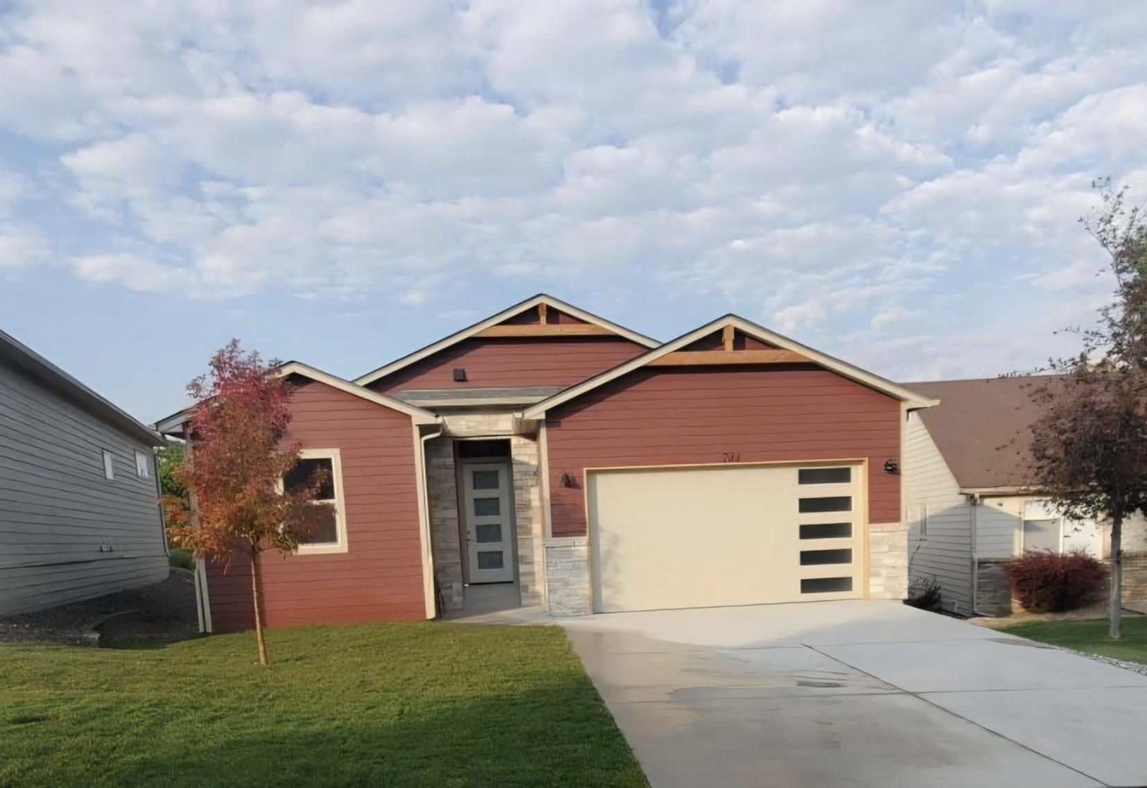 a front view of a house with a yard and garage